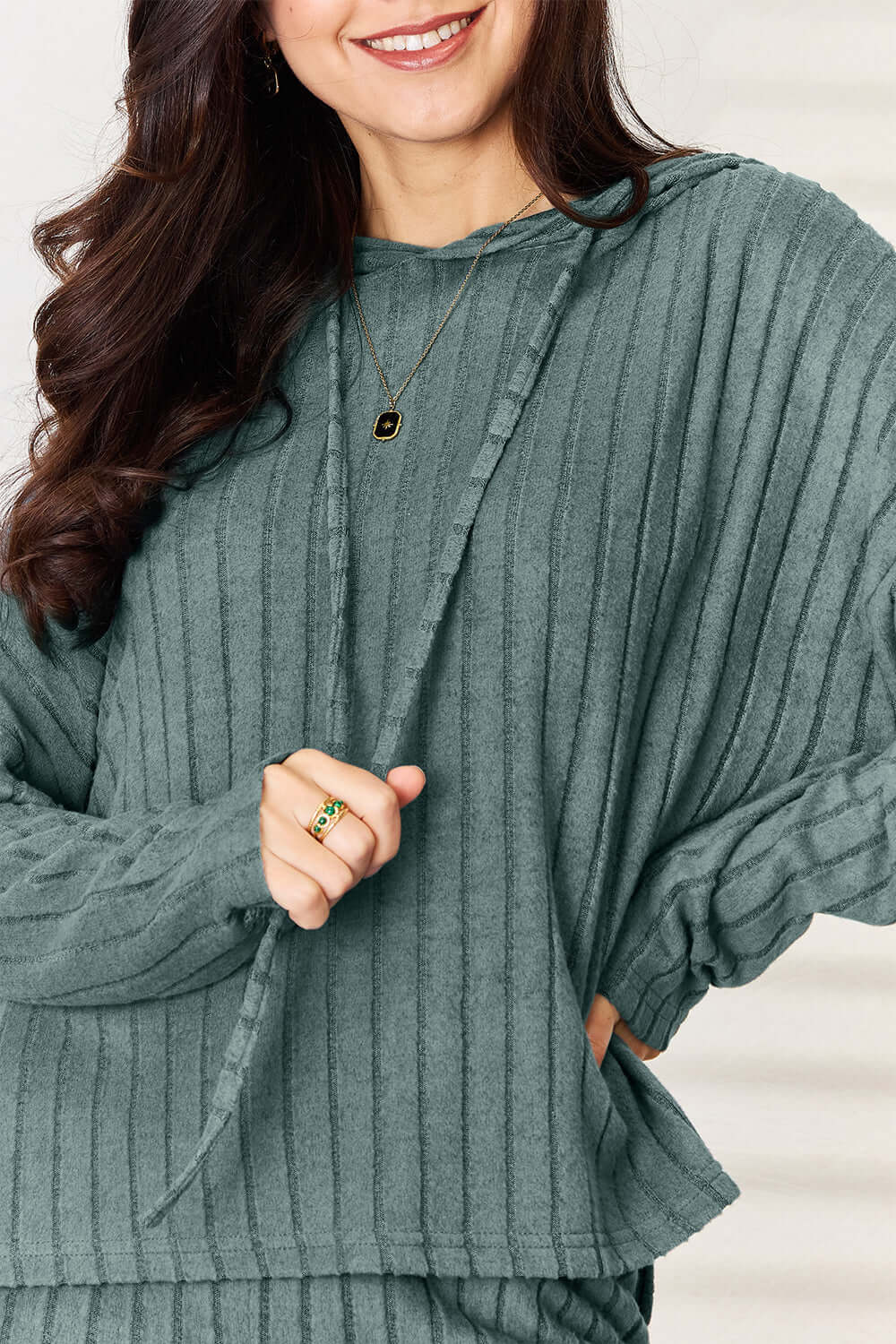 Model wearing a ribbed drawstring hooded top in teal, showcasing the relaxed fit and stylish design of the Basic Bae set.